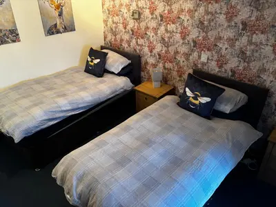 two beds in a small room with at The Bee Hive Hotel in Coylton