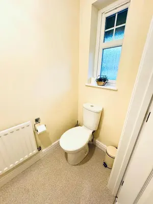 a bathroom with a toilet and a window at Linga House - 3 Bedrooms - Sleeps 5 in Frizington