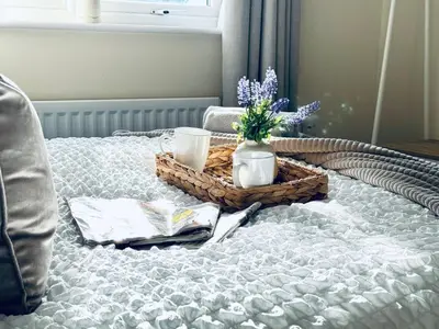 a bed with two baskets and flowers on it at Linga House - 3 Bedrooms - Sleeps 5 in Frizington