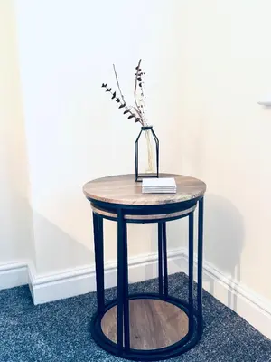 a small round table with a vase on it at Linga House - 3 Bedrooms - Sleeps 5 in Frizington