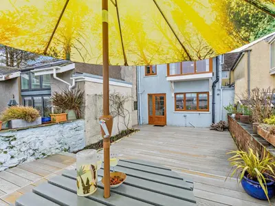 a yellow umbrella sitting on top of a wooden deck at 2 Bed in Ravenglass oc-95884 in Ravenglass