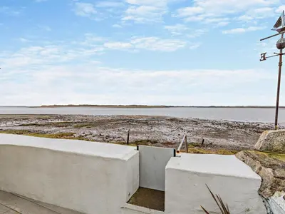 a view of a body of water with a windmill at 2 Bed in Ravenglass oc-95884 in Ravenglass
