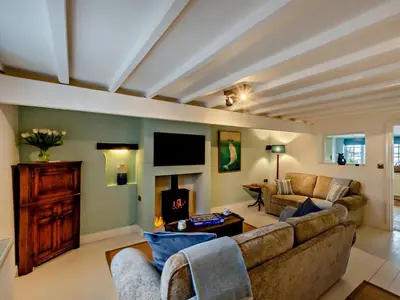 a living room with a couch and a fireplace at 2 Bed in Ravenglass oc-95884 in Ravenglass