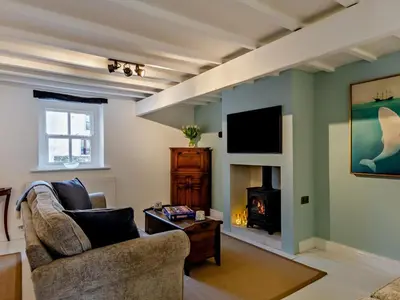 a living room with a couch and a fireplace at 2 Bed in Ravenglass oc-95884 in Ravenglass