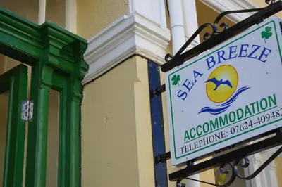 a sign on the side of a building at Sea Breeze Guest House in Douglas