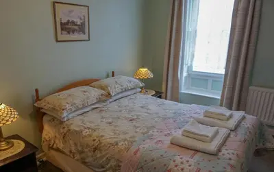 a bedroom with a bed with towels on it at Manor House Hotel, Cockermouth in Cockermouth