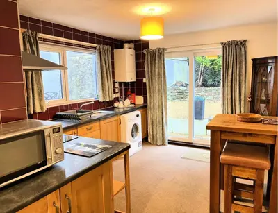 a kitchen with a sink and a microwave at Manor House Hotel, Cockermouth in Cockermouth