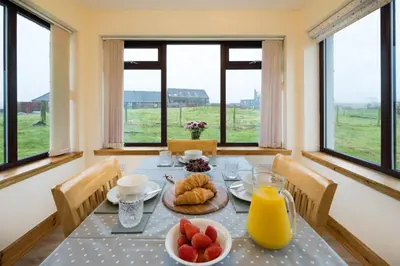 a dining room with a table with fruit on it at Shellhill Cottage at Clauchan Holiday Cottages in Gatehouse of Fleet
