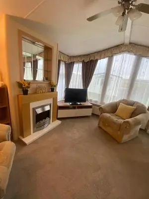 a living room with a couch and a fireplace at Skiddaw Lodges- The Lake District in Plumbland