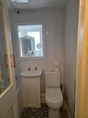 a small bathroom with a toilet and a sink at Cute Cottage in Historic Port Carlisle 12miles from M6 in Port Carlisle
