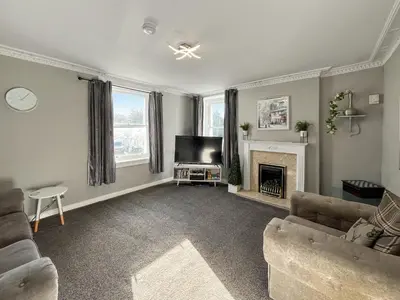a living room with a couch and a fireplace at Fleet Townhouse in Gatehouse of Fleet