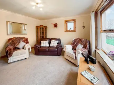 a living room with two chairs and a couch at Shellhill Cottage in Kirkcudbright