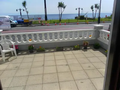 a balcony with a white fence and a view of the ocean at isle of man holiday apartment in Douglas