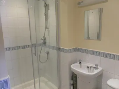 a bathroom with a shower and a sink at isle of man holiday apartment in Douglas