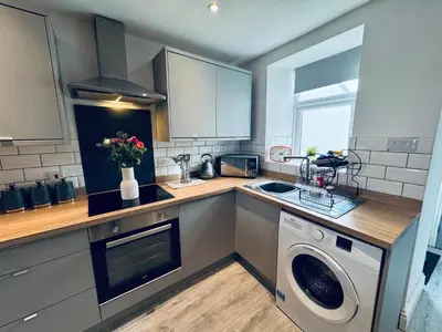 a kitchen with a sink and a washing machine at Keekle Cottage - 2 Bedrooms - Sleeps 4 in Cleator Moor