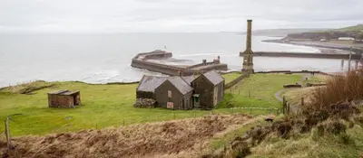 an old house on a hill next to the ocean at Keekle Cottage - 2 Bedrooms - Sleeps 4 in Cleator Moor