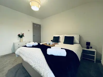 a bedroom with a large bed with towels on it at Keekle Cottage - 2 Bedrooms - Sleeps 4 in Cleator Moor