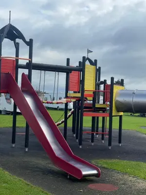 a playground with a slide in a park at Lyons Manor House Caravan Park in Mawbray