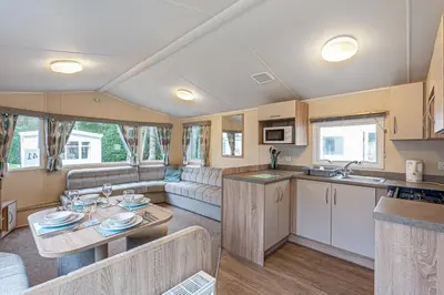 a kitchen and living room of a caravan at Lyons Manor House Caravan Park in Mawbray