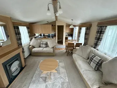 a living room with a couch and a table at 28 The Beeches in Wigton
