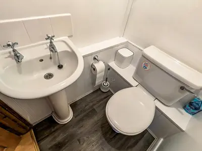 a small bathroom with a toilet and a sink at Prior Bank in Canonbie
