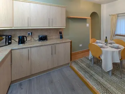 a kitchen with a table and a counter top at Prior Bank in Canonbie