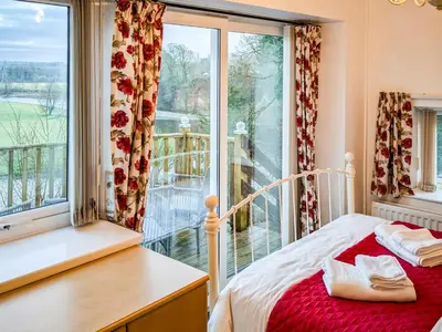 a bedroom with a bed and a large window at Prior Bank in Canonbie