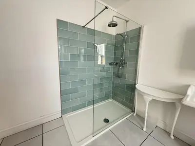 a bathroom with a glass shower with a sink at 45 Eskin Street in Keswick