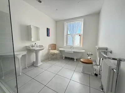 a bathroom with a sink and a tub and a toilet at 45 Eskin Street in Keswick