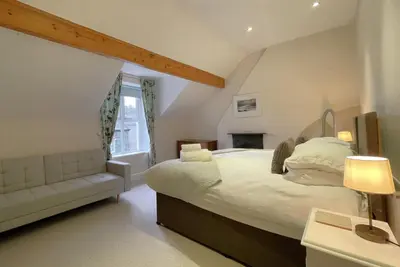 a bedroom with a large bed and a window at 45 Eskin Street in Keswick