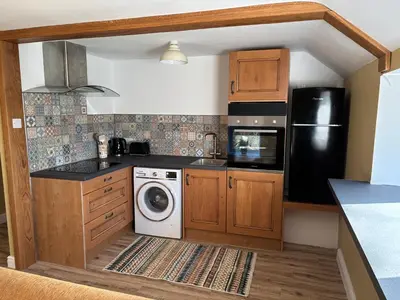 a kitchen with a washer and dryer at The Barn in Ellonby