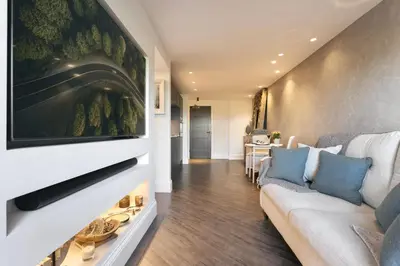 a living room with a couch and a tv at The Retreat - Ridgestone in Penruddock