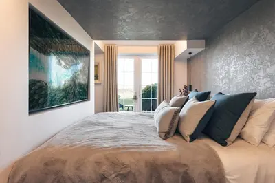 a bedroom with a large bed with pillows on it at The Retreat - Ridgestone in Penruddock
