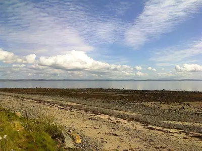 a dirt road next to a body of water at Ardwell House East Lodge in Stranraer