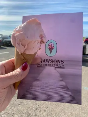 a person holding a pink ice cream cone at Lilac Cottage - Fell views & walks from the door in Cleator Moor
