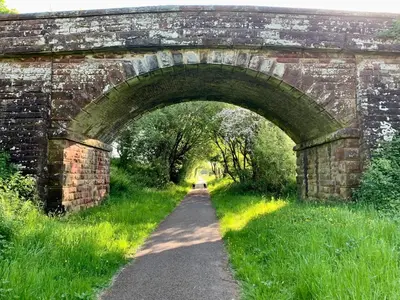 an old stone bridge with a path under it at Lilac Cottage - Fell views & walks from the door in Cleator Moor