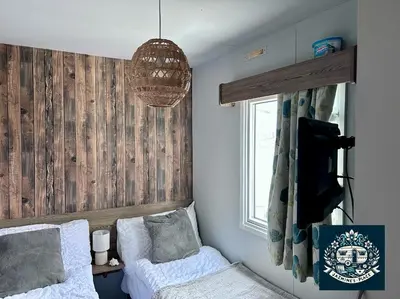 a bedroom with a bed and a tv and a window at Jazmine's Place in Ayr