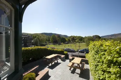 a patio with benches and a view of a parking lot at Berkeley House in Keswick