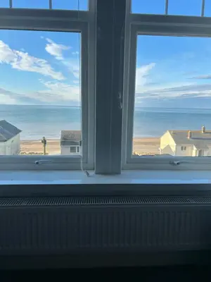 an open window with a view of the beach at Lakenhow in Seascale