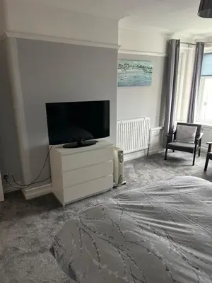 a bedroom with a flat screen tv on a dresser at Lakenhow in Seascale