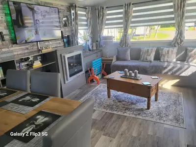 a living room with a couch and a tv at MLR at Craig Tara Bay View in Ayr
