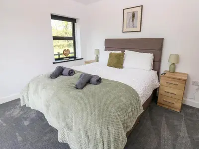 a bedroom with two beds with towels on them at Oaktree Cottage - 3 Bedrooms - Sleeps 6 in Frizington