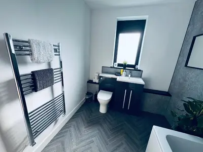a bathroom with a toilet and a sink and a mirror at Sycamore Cottage - 2 Bedrooms - Sleeps 4 in Frizington