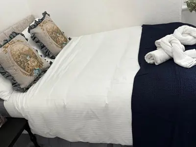 a bed with towels on top of it at Athol House in Douglas