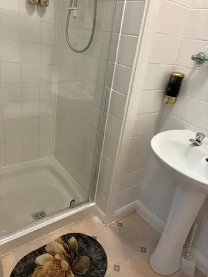 a bathroom with a shower and a sink at Athol House in Douglas