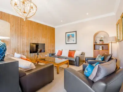 a living room with two couches and a tv at Piersland Mews in Troon
