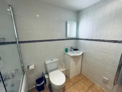 a bathroom with a toilet and a sink and a shower at Pears Suite - 1 Bedroom - Sleeps 2 in Whitehaven