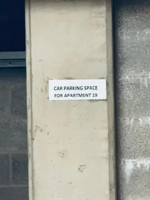a car parking space sign on the side of a building at Pears Suite - 1 Bedroom - Sleeps 2 in Whitehaven