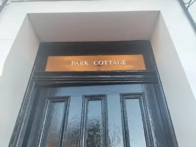 a black door with a sign that reads park cottage at Park Cottage - Spacious & Luxurious Room in B Listed Cottage in Moffat