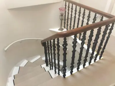 a staircase with a wooden rail and a stair case at Park Cottage - Spacious & Luxurious Room in B Listed Cottage in Moffat